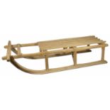 A vintage pine sledge with slatted seat upon turned supports with metal runners width 26.5 x 117 x