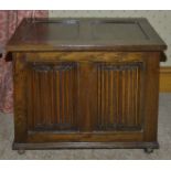 An oak coffer, 20th century of small proportions with two panelled top and two linen fold carved