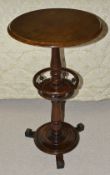 A mahogany circular top side table, 19th century with baluster turned column and turned central