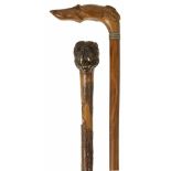 Two late 19th century/early 20th century walking sticks with dog handles the first realistically