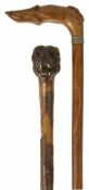 Two late 19th century/early 20th century walking sticks with dog handles the first realistically