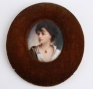 A 19th century oval porcelain painted portrait of a young girl, mounted in a velvet frame, paper