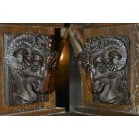 A pair of carved oak rams heads, 19th century each depicting a rams head upon a rectangular carved