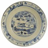 A large Chinese late 17th/18th Century Swatow blue and white pottery charger the centre painted with