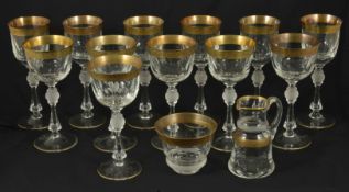 A suite of twelve crystal wine glasses, 20th century with gilt rim band of foliate decoration on