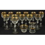 A suite of twelve crystal wine glasses, 20th century with gilt rim band of foliate decoration on