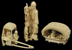 A Japanese ivory figure of a man and boy the man holding a hatchet, together with a Chinese ivory