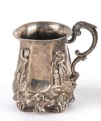 A Victorian silver tankard, London 1855 of tapering fluted form, with four applied figures, raised