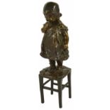 Juan Clara, Spanish (1875 - 1958) a bronze figure of a young girl standing upon a rush seated