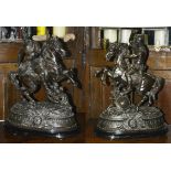 A pair of large early 20th century Spelter figures of warriors on horseback each on ebonised oval