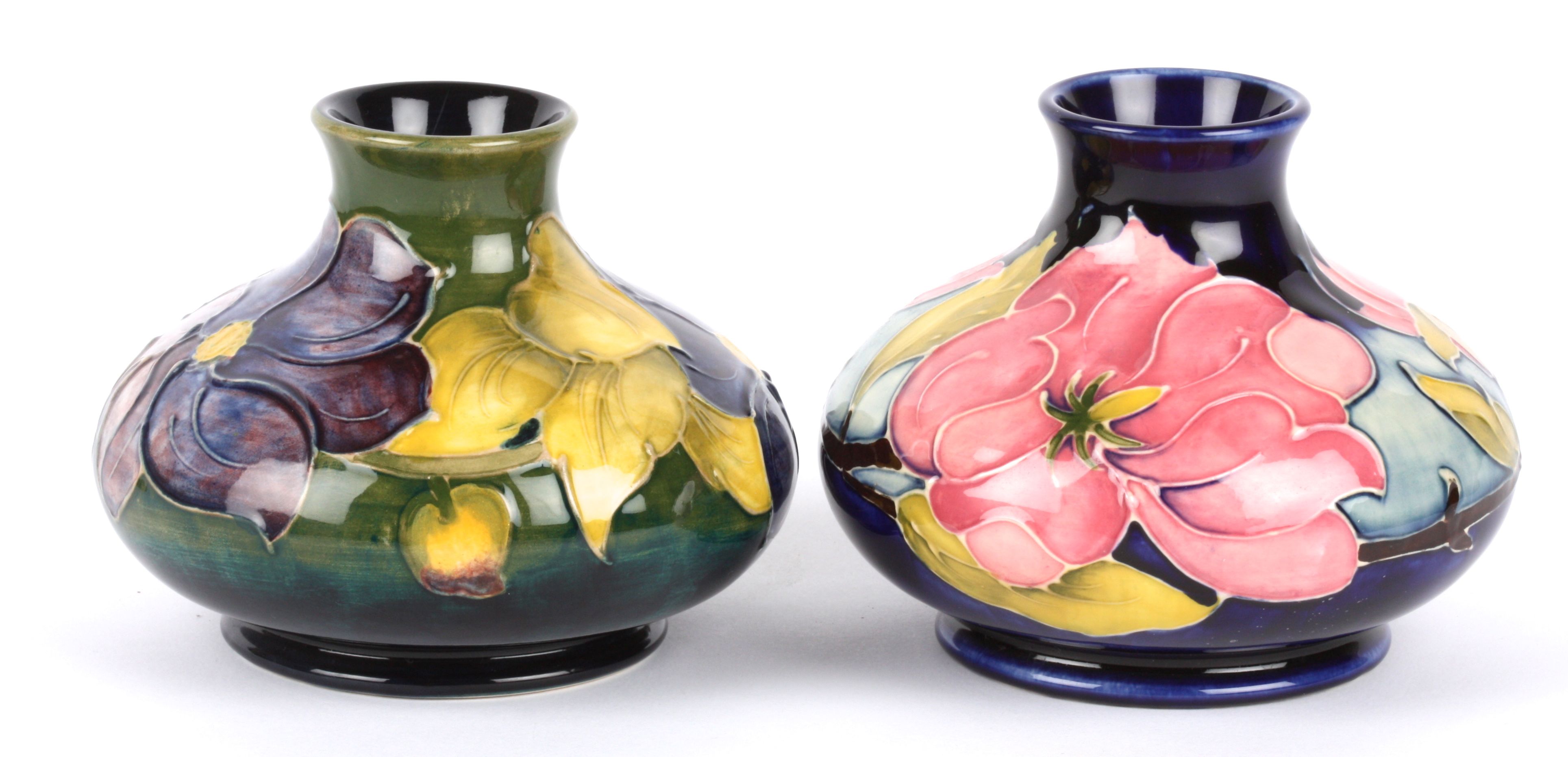 Two William Moorcroft tube lined squat vases, 20th century each decorated with floral sprays of