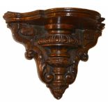 A mahogany wall bracket, 19th century the shaped shelf above egg and dart turned body with