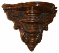 A mahogany wall bracket, 19th century the shaped shelf above egg and dart turned body with