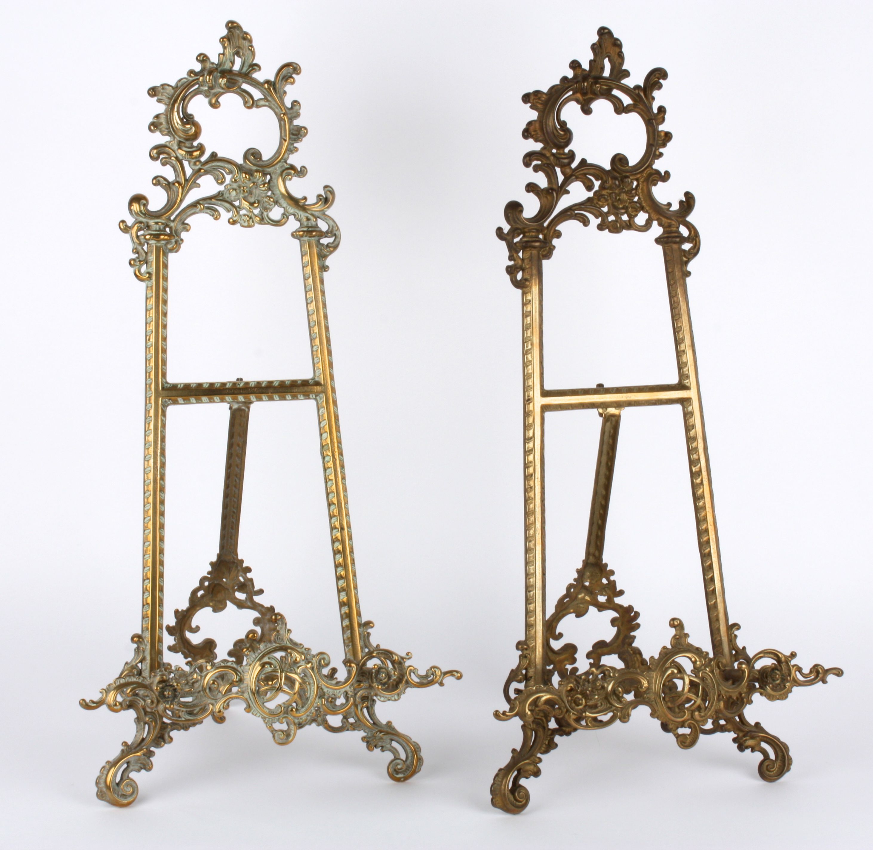 A pair of brass decorative easels, 20th century of typical easel form with pierced and scrolled