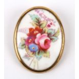 A vintage Royal Worcester porcelain brooch the oval brooch painted with a spray of summer blooms