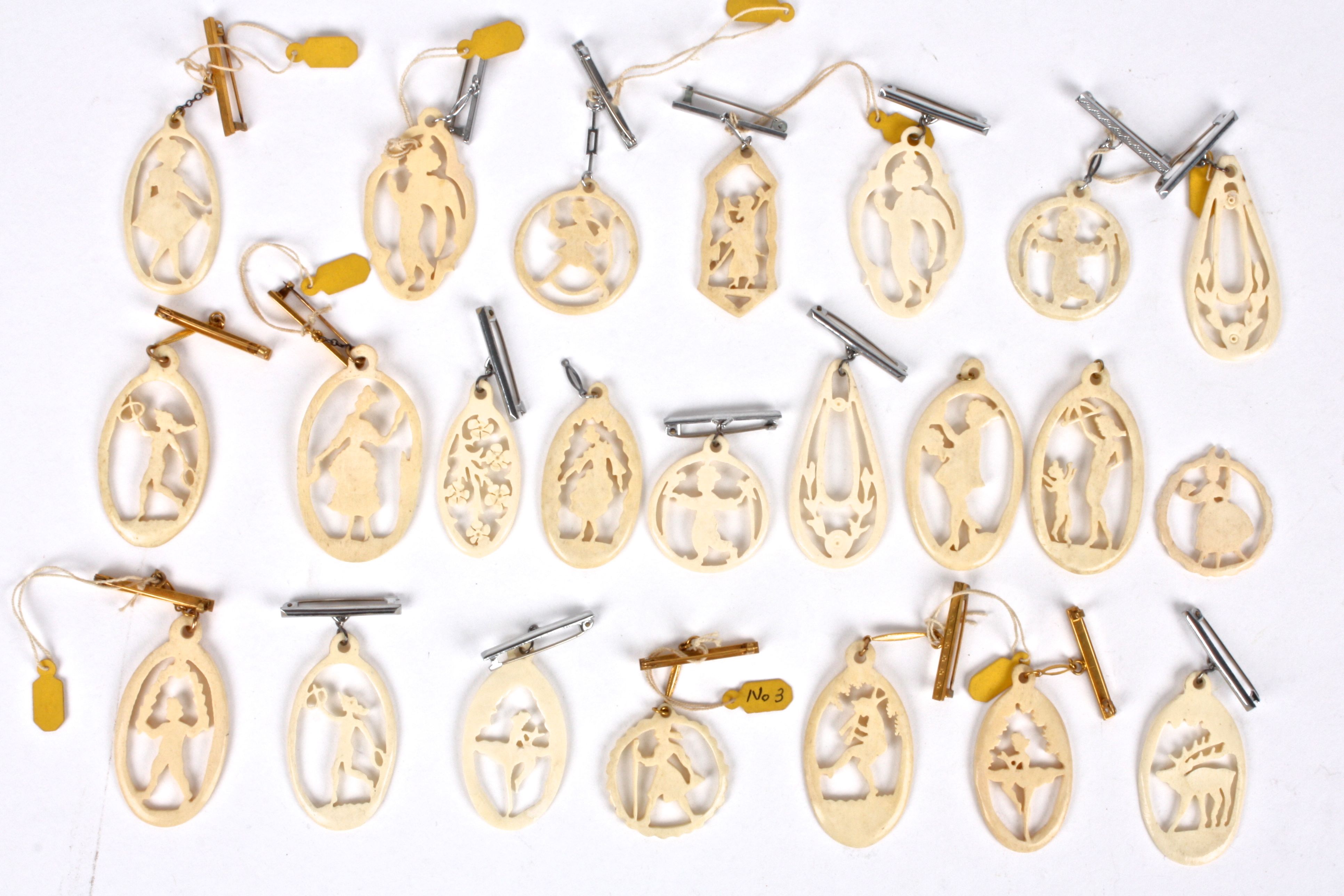 A similar collection of Art Deco ivory silhouette carvings with pendant/brooch fittings (qty)