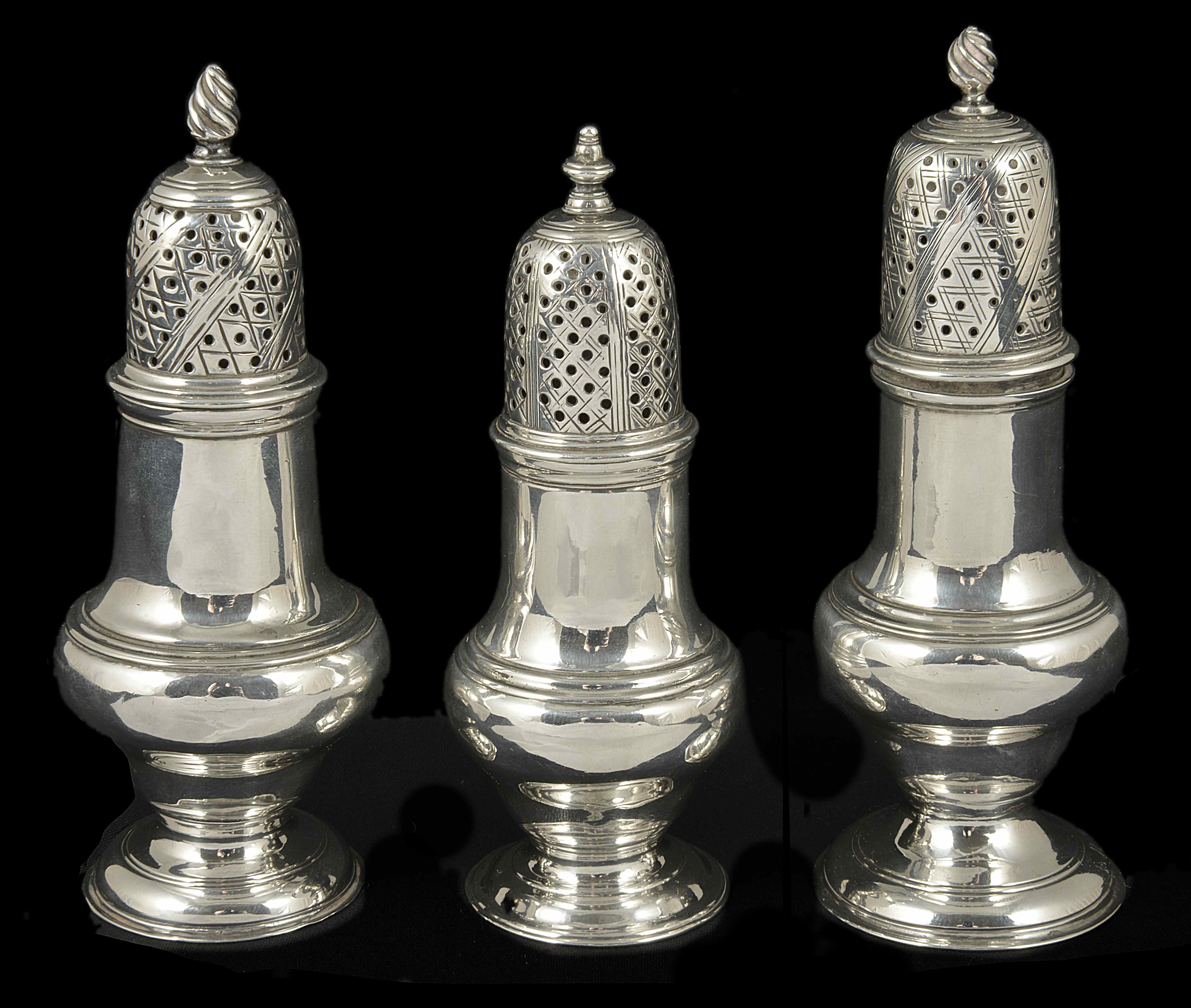Three George III silver casters, London 1759/1767/1775 each of typical baluster form with wrythen