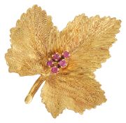 A Continental 18ct gold and ruby set maple leaf brooch the leaf with naturalistic finish set with