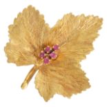 A Continental 18ct gold and ruby set maple leaf brooch the leaf with naturalistic finish set with