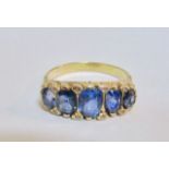 An antique five stone sapphire half hoop ring the sapphires in yellow metal (tests gold) scroll