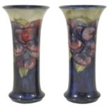 A pair of William Moorcroft pottery cylindrical vases, circa 1916 - 1929 tube lined with pansy