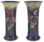 A pair of William Moorcroft pottery cylindrical vases, circa 1916 - 1929 tube lined with pansy