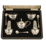 A George V cased silver cruet suite, Birmingham 1929 comprising two pepperettes, two salts with