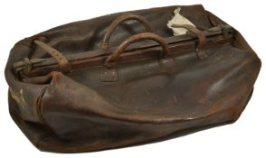 A large Gladstone leather travel bag, with central brass mounted opening and two handles, A/F 60 x