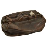 A large Gladstone leather travel bag, with central brass mounted opening and two handles, A/F 60 x