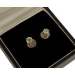 A pair of small single stone diamond set earrings each approx. 0.20ct, set in white metal screw