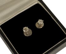 A pair of small single stone diamond set earrings each approx. 0.20ct, set in white metal screw