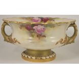 A Royal Worcester twin handled pedestal centre bowl, painted by Reginald Austin, dated 1910 the