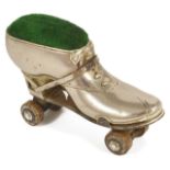 A ladies novelty Edwardian roller skate pin cushion the metal boot with heel and ribbon tie,