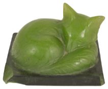 Amalric Walter (French 1870 - 1959) a green pate-de-verre model of a fox cub seated upon a plinth