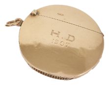 An Edwardian 9ct rose gold circular vesta case by Asprey & Co. of slim construction with hinged