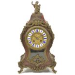 A French red stained Boulle mantle clock circa 1860 the twelve piece enamel cartouche dial, bell