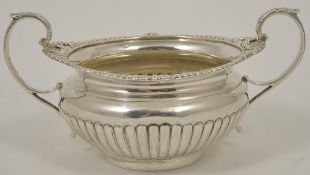 An Edwardian silver twin handled sugar bowl, London 1903 with gadrooned border and reeded base,