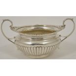 An Edwardian silver twin handled sugar bowl, London 1903 with gadrooned border and reeded base,