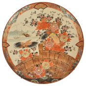 A Japanese charger, late 19th/early 20th century of circular form with a orange, black and gilt