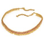 An attractive Indian gold and ruby set choker of fine boteh design fully articulated, the single