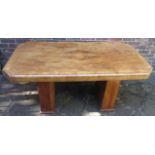 An Art Deco burr walnut dining table, of canted rectangular form with two rectangular sectioned