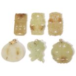 A collection of six Chinese carved hard stone pendants, 20th Century one white of globular form