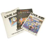 Three items of rock ephemera including a Live Aid programme together with an official Live Aid