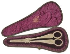 A pair of Victorian silver grape scissors, London 1884 of typical form with foliate engraved