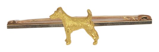 An Art Deco gold 'Terrier' dog bar brooch the 'yellow gold' Terrier set against a rose and white