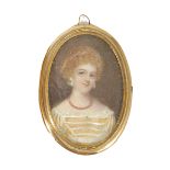 An oval painted miniature on ivory of a lady, late 19th century, a blue jewelled head dress over her
