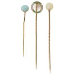 A delicate Edwardian emerald and diamond stick pin and two others, the emerald pin of circular