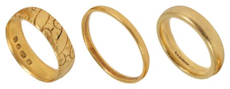 A 22ct gold wedding band and two 18ct gold wedding bands, one with engraved decoration (3) 22ct