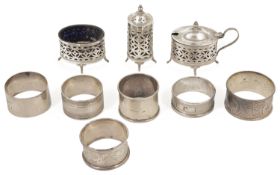 A collection of silver cruets and napkin rings a pierced three piece silver cruet set hallmarked