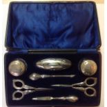 A George V silver mounted manicure suite, Birmingham 1921 comprising of a nail buffer, scissors,